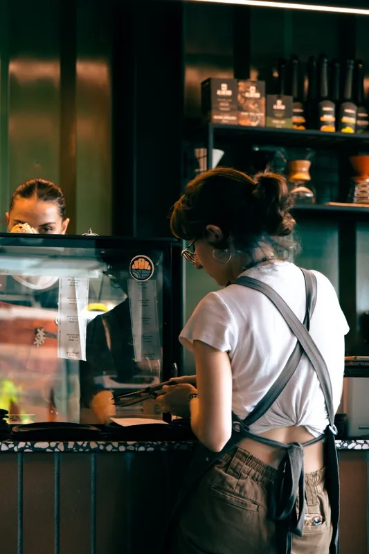 Small business owner working behind a cafe counter