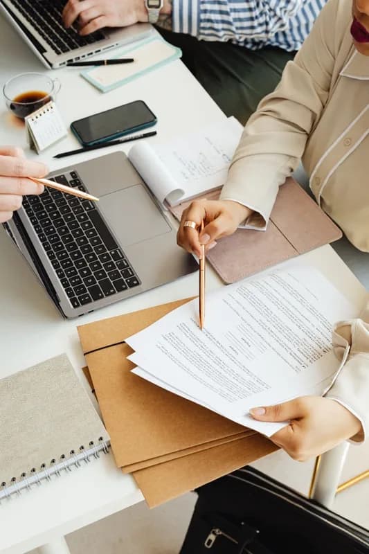 Consultants reviewing documents together at a desk