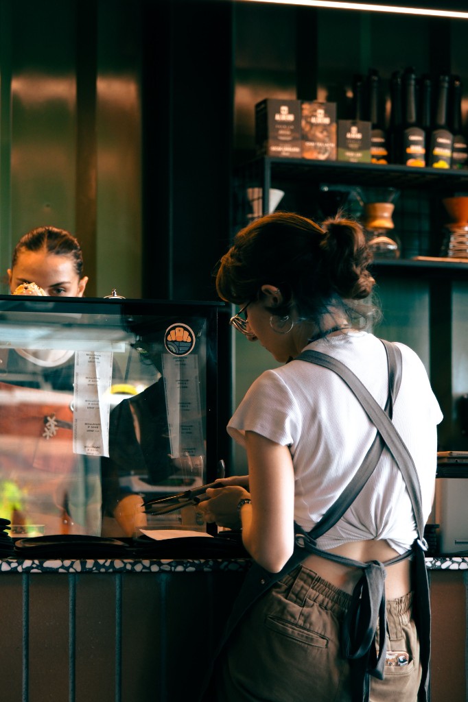 Small business owner working behind a cafe counter